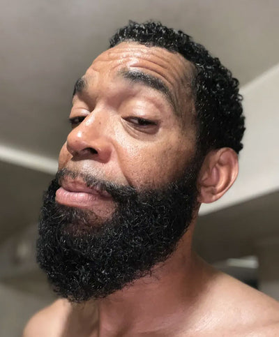 Black man showing his hair and beard